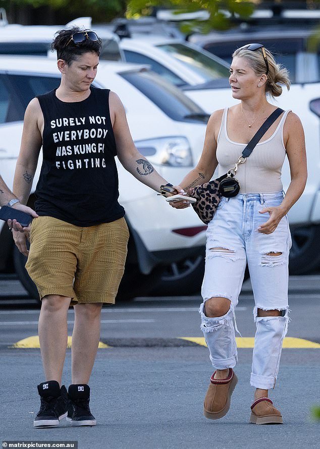 Natalie, who came out as queer last year, went braless in a cream singlet top, wide ripped jeans and Ugg boots, accessorizing her look with a leopard print shoulder bag and understated jewelry