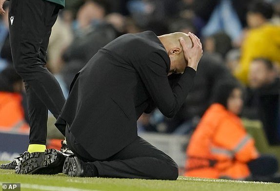 Manchester City's head coach Pep Guardiola reacts during the Champions League quarter-final between Manchester City and Real Madrid at the Etihad Stadium in Manchester, England, Wednesday, April 17, 2024. (AP Photo/Dave Thompson)