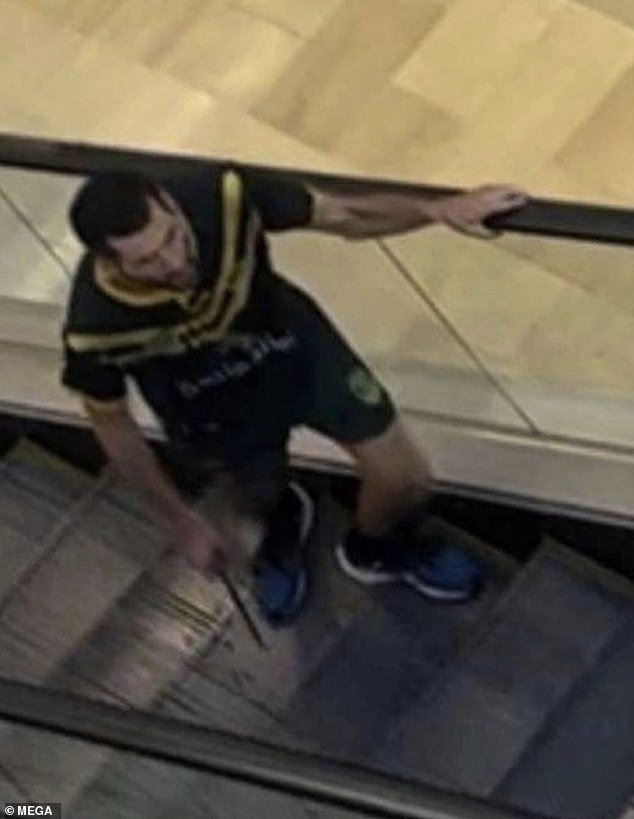 Joel Cauchi from Queensland is pictured with a 30cm hunting knife on the escalator at Westfield shopping center at Bondi Junction on Saturday afternoon
