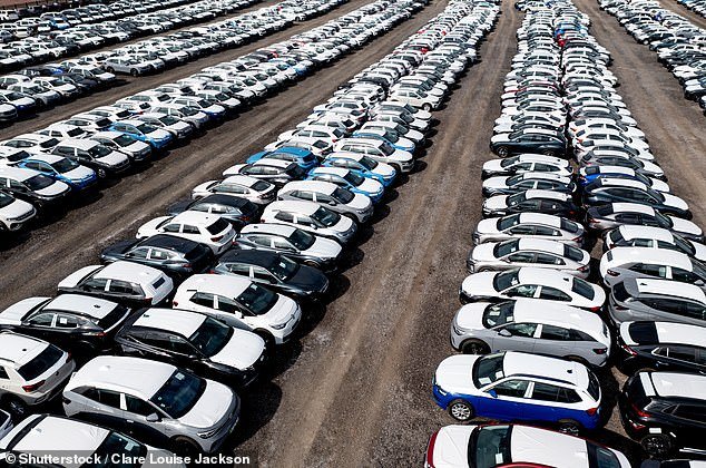 An aerial view of rows of newly built cars and vehicles ready for export and import and delivery to sales dealers in Tamworth, UK