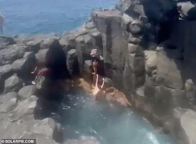 Witnesses could be heard reacting in shock and fear as the unlucky jumper made contact with the rocks before bouncing back into the water