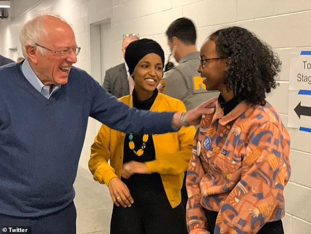 Self-proclaimed Democratic Socialist Sen. Bernie Sanders, I-Vt., hugs Hirsi as her mother, Rep.  Ilhan Omar, watching