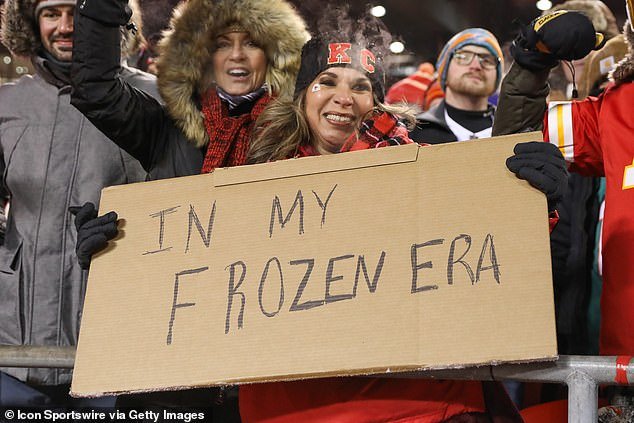 A Kansas City Chiefs fan holds a sign that reads In My Frozen Era, referring to Taylor Swift
