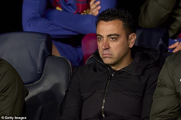 Xavi looks miserable on the bench during Barcelona's Champions League debacle