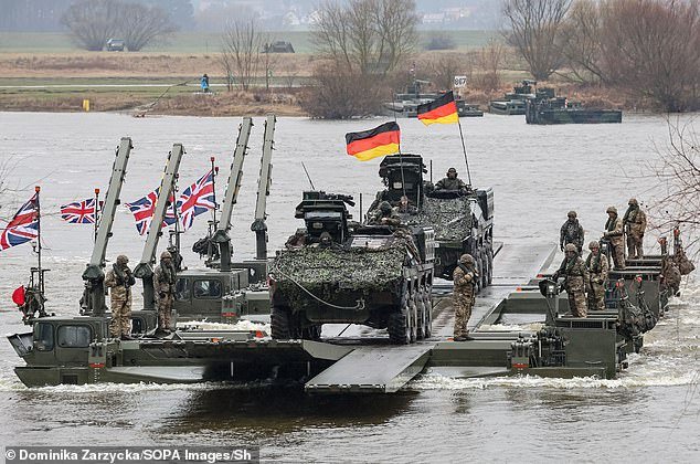 German and British soldiers move tanks and armored vehicles via the Vistula River during NATO exercise Dragon-24, part of the large-scale exercise Steadfast Defender-24