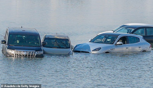 Vehicles were abandoned after the flash floods hit and remain drowned in water