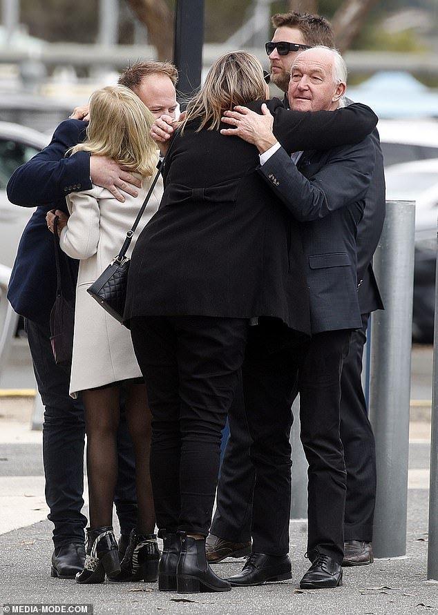 Friends of Nathan Templeton hugged each other outside the Geelong Cats home ground on Friday