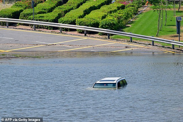 A car becomes stranded on a flooded street in Dubai after heavy rain on April 18, 2024