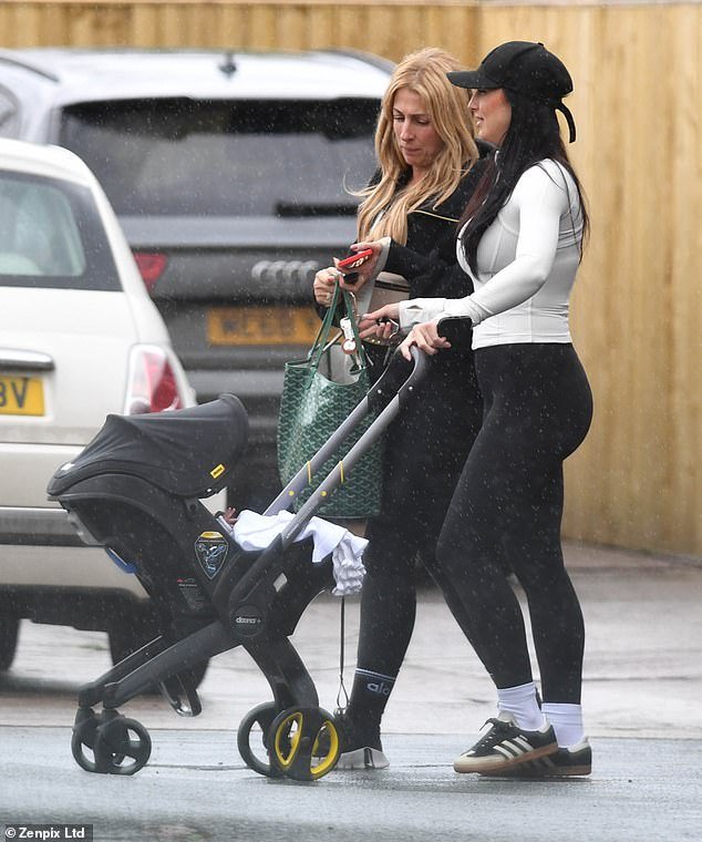 During her outing with a friend, the new mum beamed as she pushed the toddler in a £339 Doona+ car seat and pushchair Nitro Black and wore sportswear