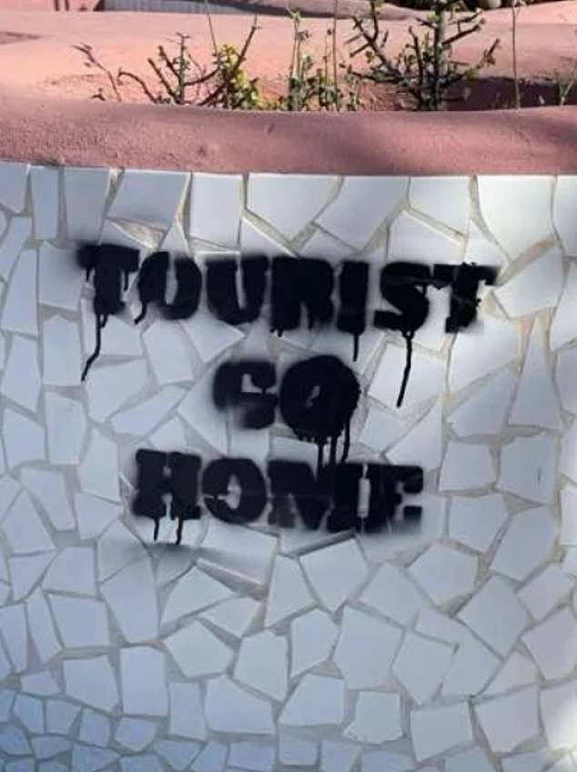 An anti-tourism message has been scrawled on the side of a bollard on the island