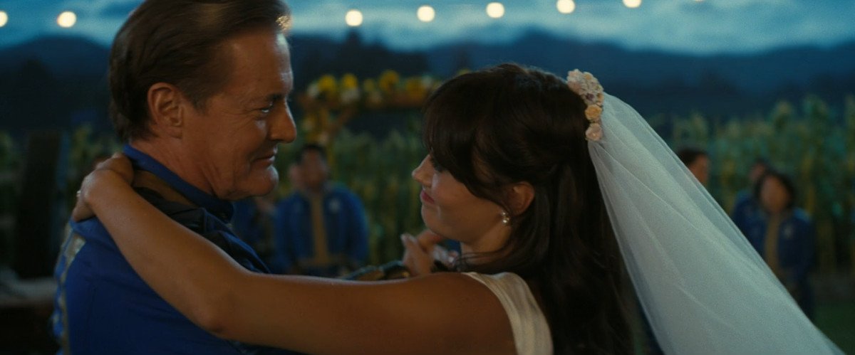 Hank (Kyle MacLachlan) and Lucy (Ella Purnell) dance at the latter's wedding in Fallout and smile at each other
