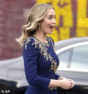 Emily completed the chic look with perfectly matching gold heels, chandelier earrings and a dazzling diamond cocktail ring