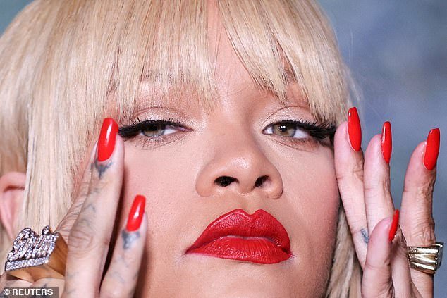 The stunner had bangs and sleek locks, paired with bold red lipstick and nails in the same color