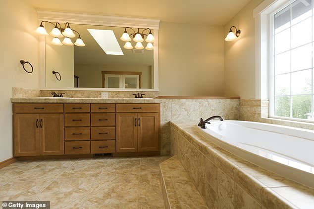 Travertine is a common and desirable material for home tiles.  It is cheaper than marble, and the veins of calcite crystals give it an interesting appearance.