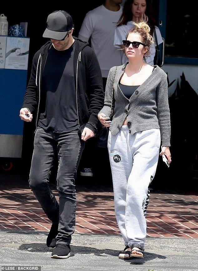 The couple each opted for a casual ensemble, with the Pretty Little Liars alum going with light gray sweatpants, a black top under a charcoal sweater and black sandals.