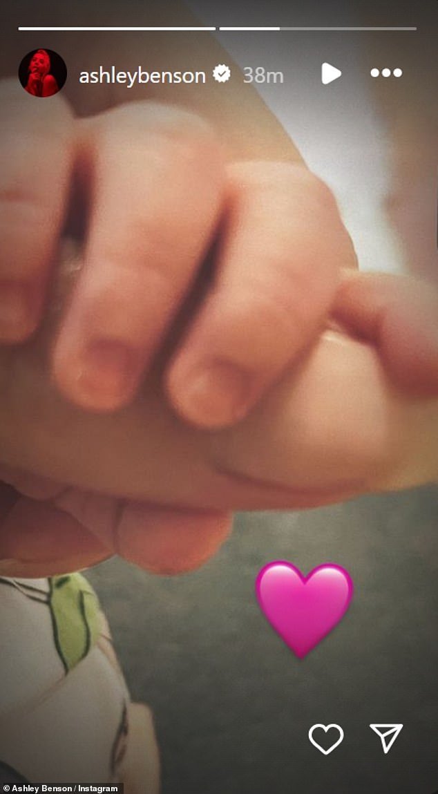 Benson announced the news of her daughter's arrival with a sweet photo of her little hand holding one of her mother's fingers