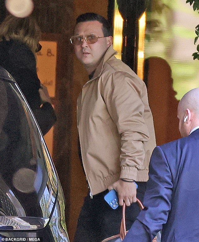 The 35-year-old completed his outfit with orange aviator sunglasses and white sneakers