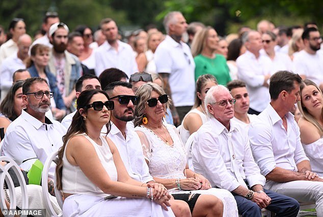 Luke Davies' mother (centre) with family and friends at Luke Davies' memorial service at New Farm Park in Brisbane