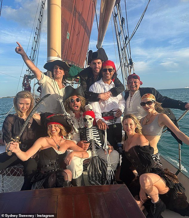 There is also an image of her among a group of people posing together in their respective pirate attire on the same sailboat