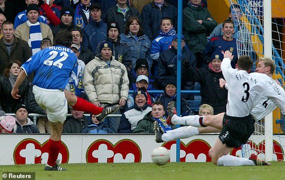 Portsmouth's Richard Hughes (L) scores the winning goal past Liverpool's Steve Finnan (2L) and Switzerland's Stephane Henchoz during their English FA Cup fifth round replay football match at Fratton Park, Portsmouth, February 21, 2004. Portsmouth won the match by 1 -0 .  NO ONLINE/INTERNET USE WITHOUT A LICENSE FROM FOOTBALL DATA CO LTD.  FOR LICENSE QUESTIONS PHONE +44 207 298 1656. REUTERS/Gerry Penny