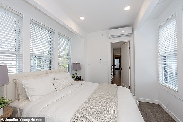 In the bedroom, a large queen bed is comfortable and there is plenty of closet fitted into the sleek white walls