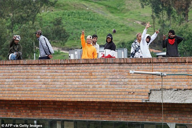Prisoners remain on the roof of Turi Prison, where prison guards are held hostage, in Cuenca, Ecuador