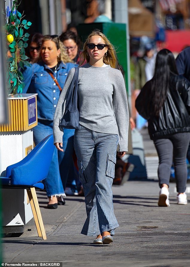 Lila was pictured in New York on Monday looking chic in striped combat trousers and a gray sweater