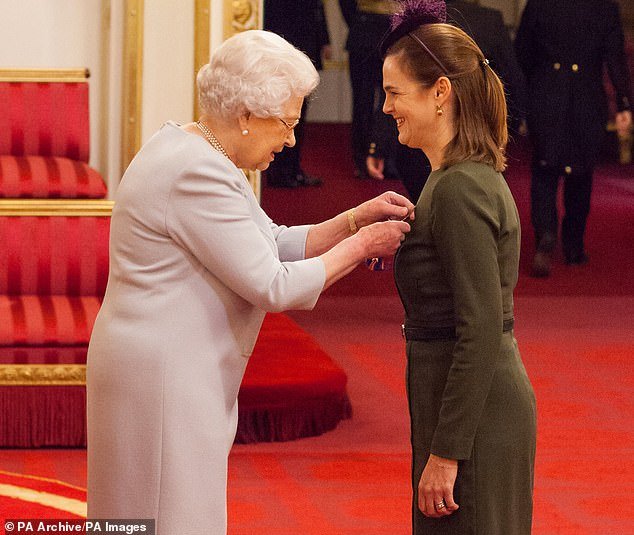 The Queen honors Samantha Cohen by appointing her Commander of the Royal Victorian Order at a ceremony at Buckingham Palace in November 2016
