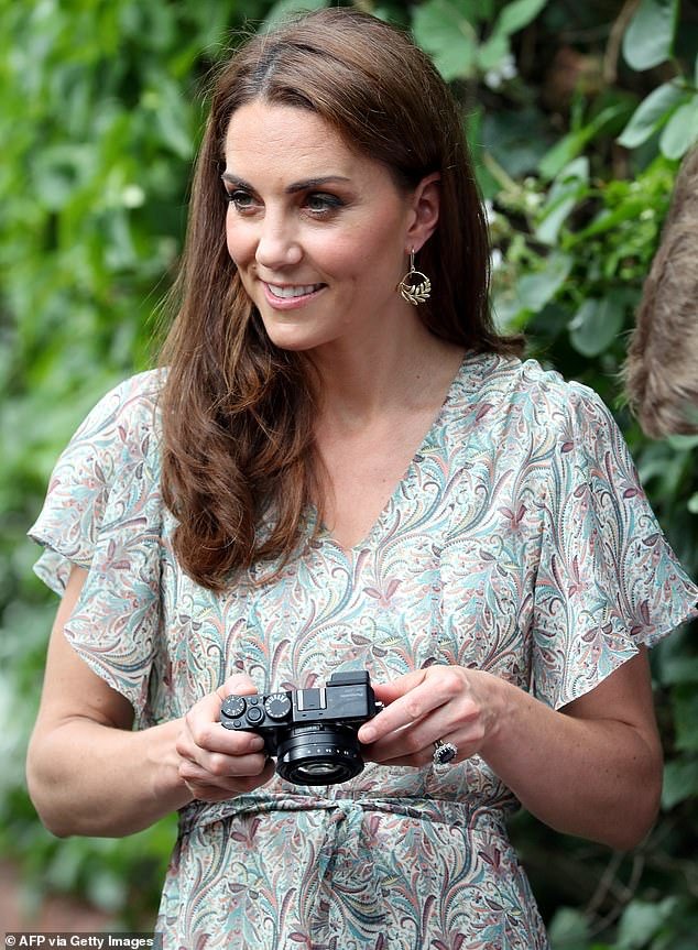 The Princess of Wales pictured with a camera as she takes part in a photography workshop with the charity 'Action for Children' in Kingston in June 2019