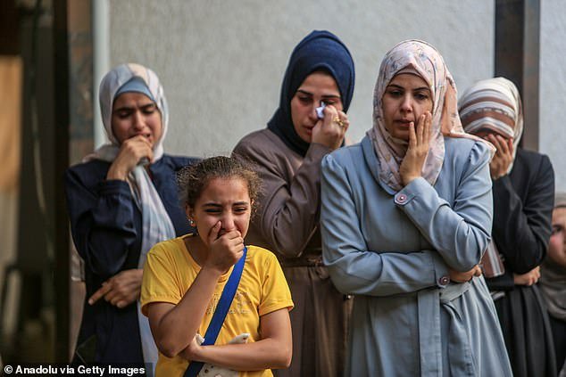 Family members of Palestinians who lost their lives as a result of an Israeli airstrike mourn