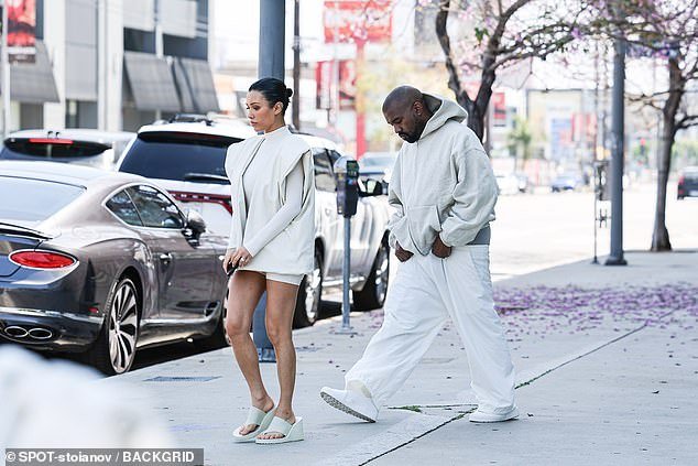 Kanye looked somber as he strolled next to his wife