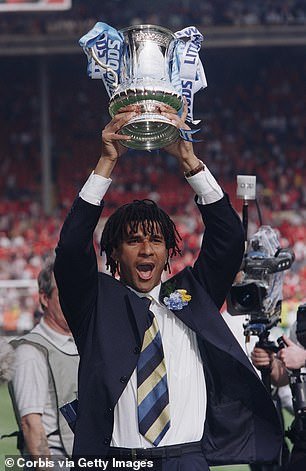 Gullit photographed celebrating with the trophy in 1997