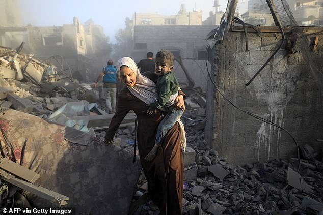 People flee after Israeli airstrikes on a neighborhood in the al-Maghazi refugee camp in the central Gaza Strip on November 6, 2023