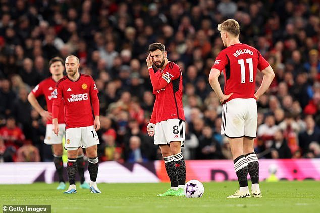 Man United captain Bruno Fernandes (centre) scratches his head after Sheffield United's second goal
