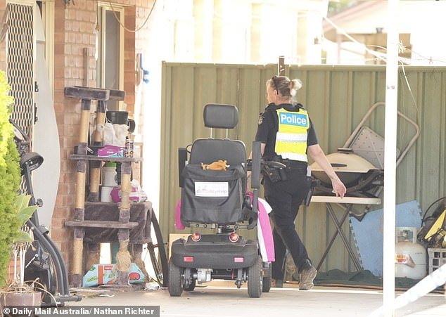A wheelchair scratching post and a cat could be seen unattended in Mrs Bates' driveway as forensic officers searched the property on Wednesday afternoon
