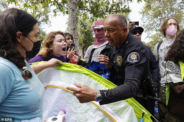 USC public safety officials seize the tents of city protesters during a solidarity occupation in Gaza on campus