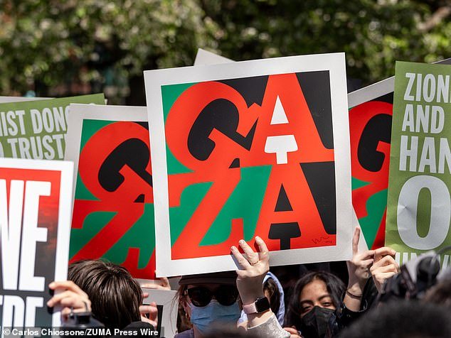 A New York University student holds a Gaza sign during a rally in Washington Square Park to protest the arrests made yesterday during the Gaza Solidarity Encampment
