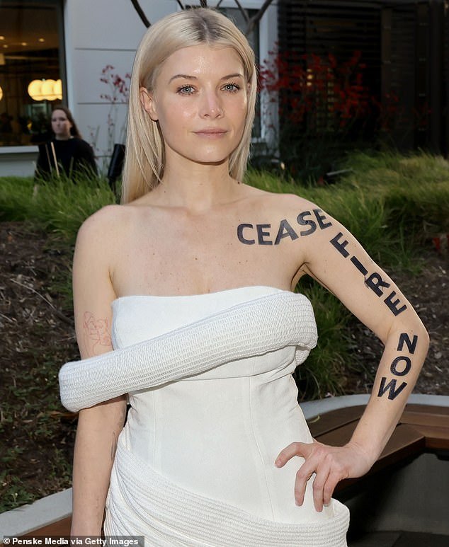 Sarah Jones, who plays Serena Croker, wore a strapless white dress with 'Cease Fire Now' written in black body paint on her left arm