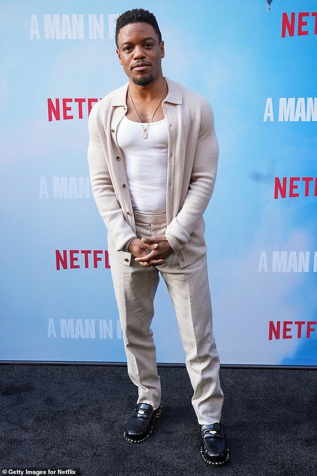 Jon Michael Hill, who plays Conrad Hensley, opted for a white tank top under a tan cardigan and matching pants with black loafers