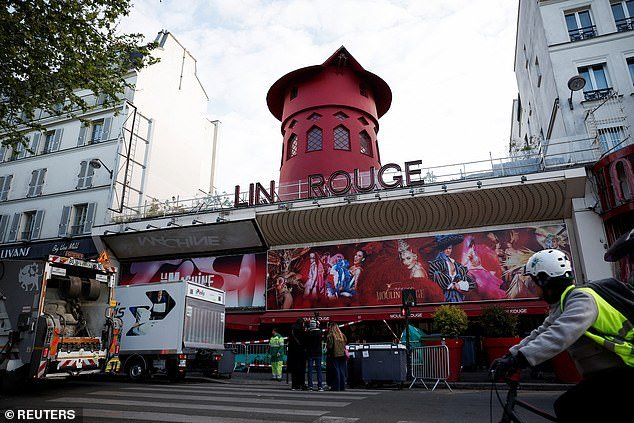 The sails of the characteristic red windmill on top of the Moulin Rouge, Paris's most famous cabaret club, can be seen on the ground