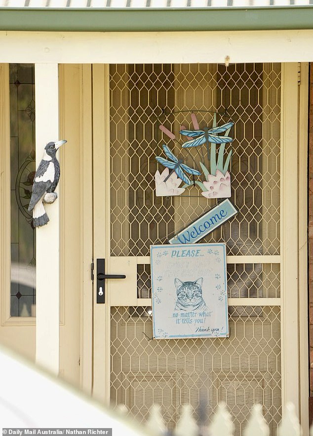Mrs Bates was described in loving terms as the 'crazy cat lady aunt' to 17 cousins ​​(photo: the door of her home)