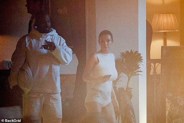 Kanye clutched an oversized white bag to match his ensemble on the outing