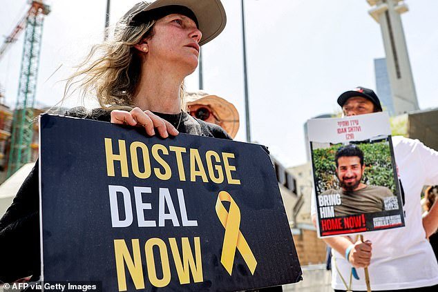 Relatives of Israeli hostages held by Palestinian militants in Gaza since the October 7 attacks, and supporters, protest outside the Defense Ministry headquarters in Tel Aviv.