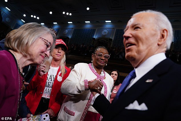 Georgia Republican Rep. Marjorie Taylor Greene (2-L) watches as U.S. President Joe Biden (R) arrives in the House Chamber of the U.S. Capitol