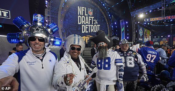 Dallas Cowboys fans pose before the first round of the NFL football draft, Thursday, April 25, 2024, in Detroit.  (AP Photo/Paul Sancya)