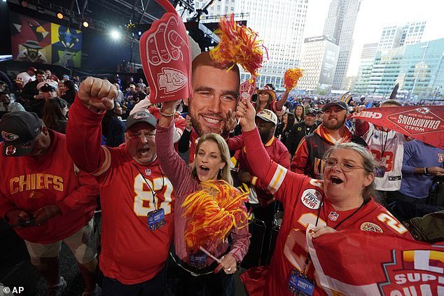 Kansas City Chiefs fans hold up a Travis Kelce cutout during the NFL Draft in Detroit on Thursday