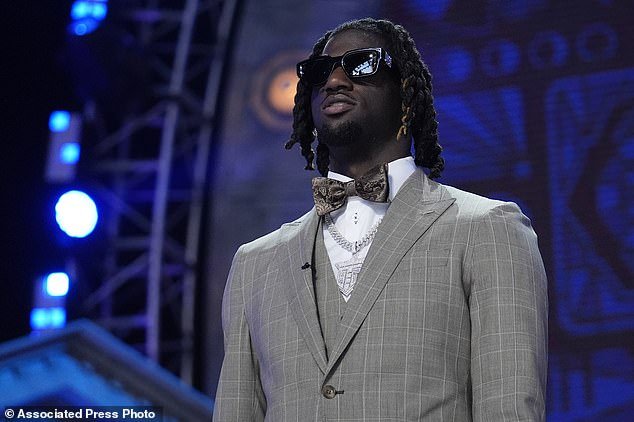 Thomas Jr.  wore a gray suit, silver chain, bow tie and sunglasses on his big draft night in Detroit