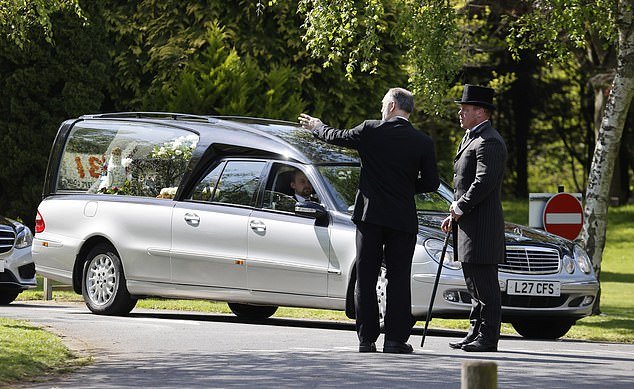 A hearse is driven for George's service which took place earlier today