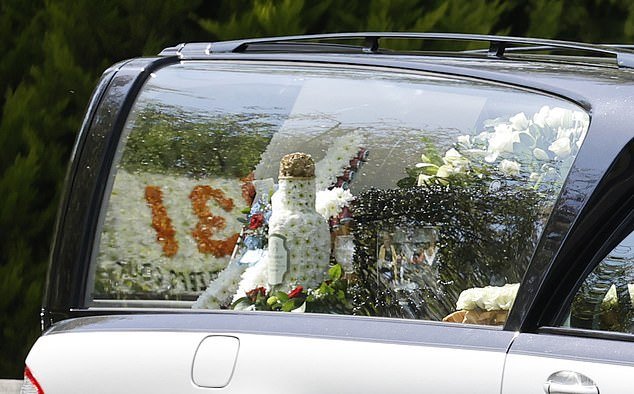 The hearse was decorated with flowers for George's service earlier today