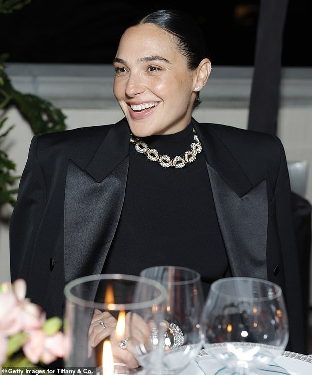 Gal brought back memories of old Hollywood as she swept back her dark hair and accessorized with a necklace and bracelets over her elegant black dress